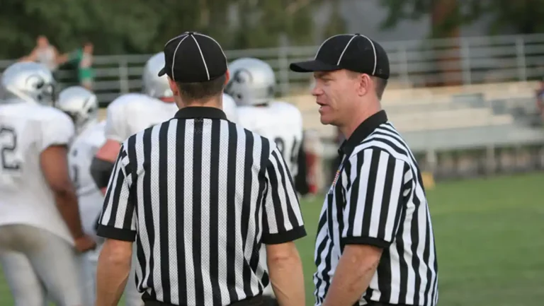 Football officials talking on the field