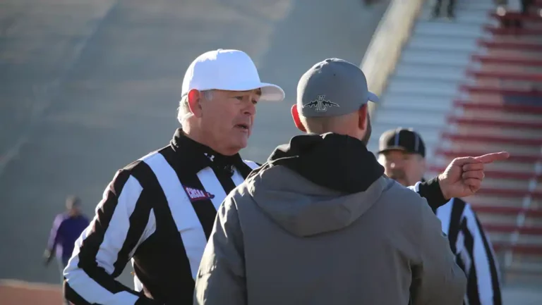 Referee speaks with coach